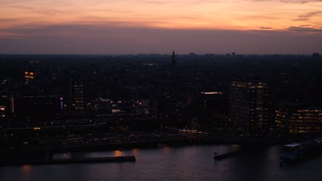 Amsterdam-skyline-after-sunset-at-night-from-above