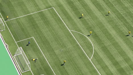 Tight-aerial-establishing-shot-of-Maidstone-FC,-telephoto-aerial-view-of-players-training-in-the-Gallagher-stadium-with-a-goal