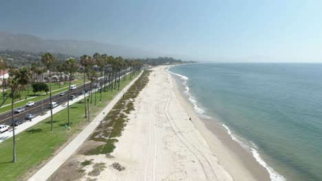 Low-altitude-aerial-number-1-of-an-empty-beach-in-Santa-Barbara,-California-during-a-warm-sunny-day