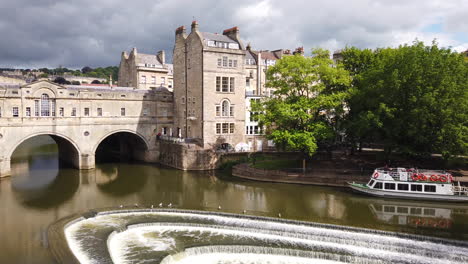 Static-Shot-of-Pulteney-Bridge---Weir-in-Bath,-Somerset-from-High-Vantage-Point-on-Summer’s-Day-with-Seagulls-Flying-Through-Frame-in-Slow-Motion