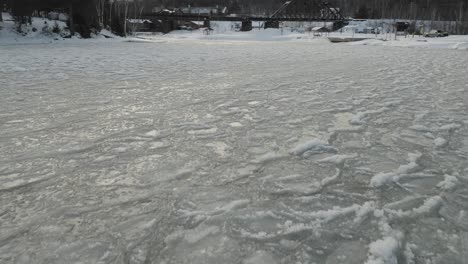 Freezing-lake-ice-sheets-aerial-4K