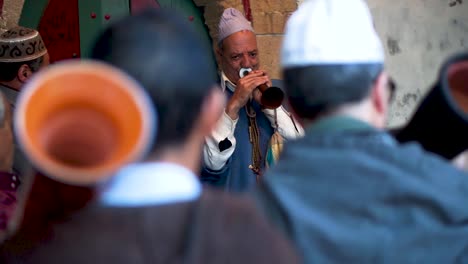 Closeup-of-two-men-playing-rhaita-or-mizmars-during-a-Sufi-trance-ceremony-in-Essaouira,-Morocco
