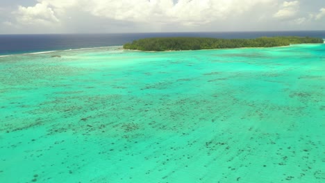 Aerial-establishing-shot-of-the-gorgeous-barrier-reef-surrounding-Mo'orea-island-in-French-Polynesia