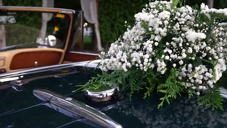 Wedding-flower-bouquet-on-convertible-classic-car,-slide-right