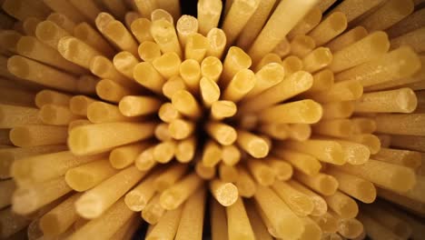 Slowly-pulling-away-from-an-open-bag-of-spaghetti,-high-magnification-showing-great-texture-of-the-ends
