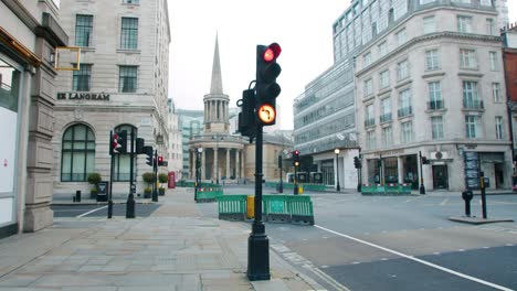 Lockdown-in-London,-gimbal-pan-of-the-BBC-Broadcasting-House-Headquarters-with-Old-Souls-Langham-Place-Church-on-empty-Regent-Street,-during-the-COVID-19-2020-pandemic