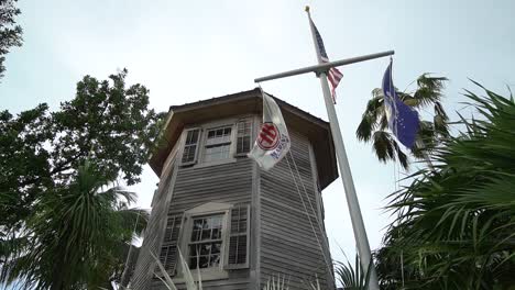 Old-Caribbean-House-With-Nautical-Flagpole-in-Front-On-a-Cloudy-Day