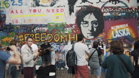 Prague,-Czech-Republic-Tourists-in-front-of-famous-graffiti-wall