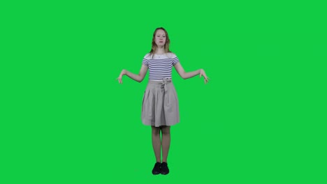 Cute-teenage-girl-relaxing,-meditating-in-front-of-a-green-screen