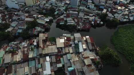 flying-in-drone-shot-over-rooftops-of-an-old-shanty-town-like,-high-density-residential-area-of-Binh-Thanh-District-of-Saigon-AKA-Ho-Chi-Minh-City,-Vietnam