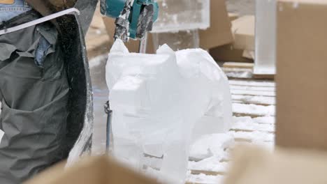 Man-with-chainsaw-carving-ice-block.-Static,-slomo