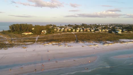 "Anna-Maria-Island,-FL---USA---11-14-2020:-Aerial-panning-clip-adjacent-to-the-shoreline-during-sunset-at-Bean-Point-Beach-in-Anna-Maria-Island