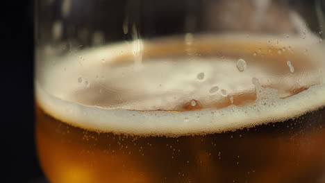 Person-puts-down-golden-foamy-cup-of-Beer-on-a-table-after-sipping-it---Close-up