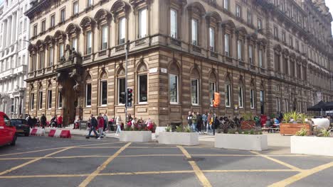Wide-shot-of-people-crossing-a-busy-Glasgow-road