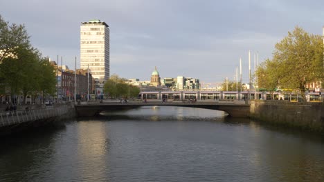 SIPTU-Headquarter-At-Liberty-Hall-With-Tram-Crossing-Rosie-Hackett-Bridge-In-Dublin,-Ireland