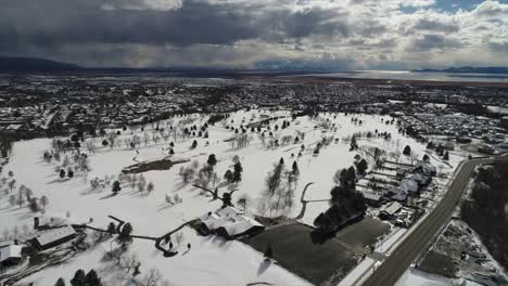 Drone-shot-panning-over-snow-covered-town-until-it-rests-over-a-beautiful-view