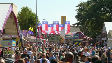 Numerous-Texas-flags-hang-over-large-bustling-walking-crowd-attending-Texas-festival----4K