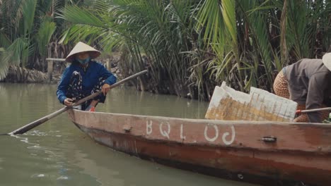 Vietnamese-Man-Sitting-on-the-Edge-of-a-Boat-on-the-Thu-Bon-River