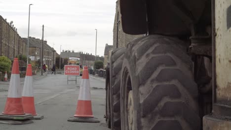 Road-closed-with-traffic-cones-and-heavy-plant-digger