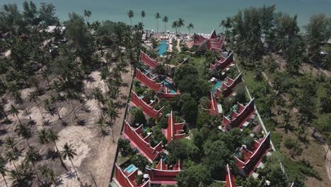 forward-dolly-birds-eye-view-shot-of-luxury-resort-on-a-tropical-Island-with-beach,-swimming-pool-and-hotel-accommodation-in-Thailand