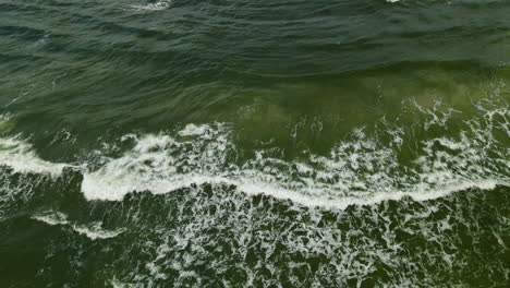 Green-Ocean-Waves-Crash-against-the-Shore,-Shot-from-Drone,-Aerial