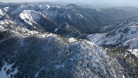 Aerial-view-of-snowy-mountain-peak-in-the-sierra-de-Espadan,-Castellon,-Spain