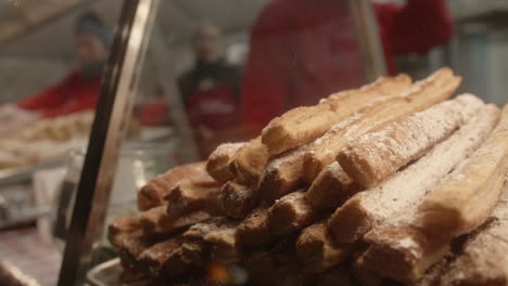 German-pastry-for-sale-in-display-case-at-Christmas-festival-in-Pennsylvania,-Slow-Motion