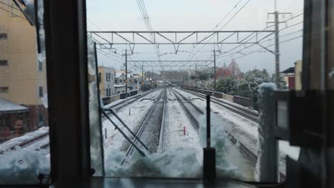 Train-traveling-through-Japan-to-Kyoto,-Snowy-Weather,-Point-of-View-Shot