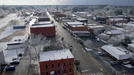 Drone-shot-of-small-town-USA-after-snowfall-into-the-sun