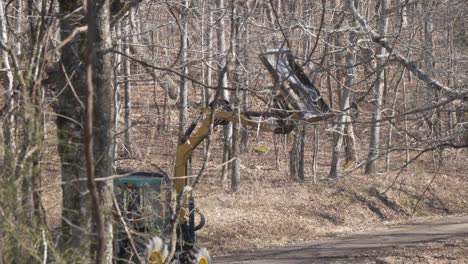 green-tractor-cutting-tree-branches-slow-motion