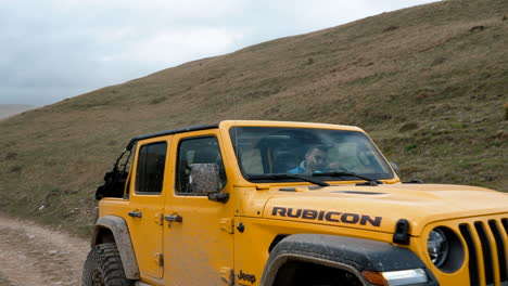 a-car-passing-through-the-walking-track-on-a-mountain