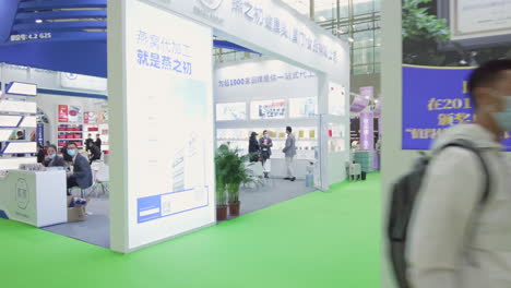 Visitors-wearing-masks-and-attending-booths-at-Health-products-exhibition-in-Guangzhou,-China-during-COVID-19-Pandemic