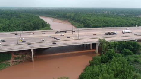 Aerial-of-cars-on-59-South-as-the-pass-over-the-Brazos-River-in-Sugarland,-Texas