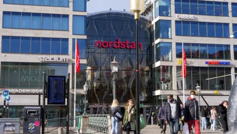 Shoppers-Entering-And-Exiting-Nordstan,-Large-Shopping-Mall-In-Gothenburg,-Sweden
