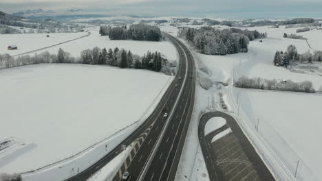 Flying-over-highway-in-snow-covered-landscape