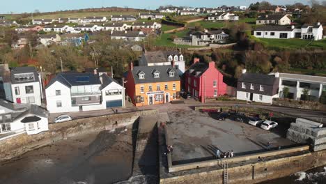 Summercove-in-Kinsale,-County-Cork,-Ireland-on-a-sunny-day-with-yellow-orange-the-Bulman-Pub-in-the-centre