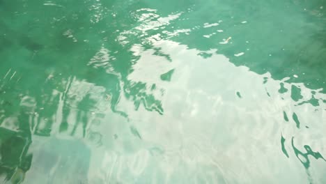 Small-waves-of-water-on-the-surface-of-the-pool
