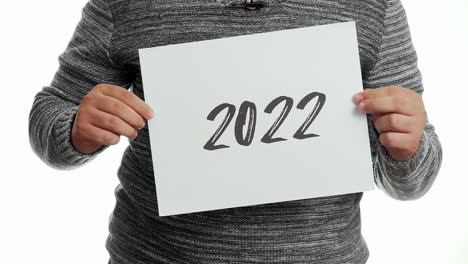 A-person-holding-a-sign-with-the-message-"2022