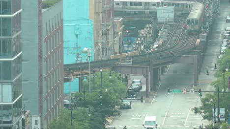 Slow-motion-downtown-Chicago-elevated-train-with-traffic-flow-and-pedestrians