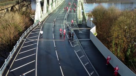 Charity-Santa-dash-fun-run-over-Runcorn-Silver-Jubilee-bridge-Aerial-view-low-zoom-in