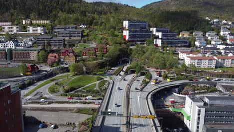 Busy-highway-555-over-Puddefjord-bridge-entering-Lovstakken-tunnel---Aerial-over-traffic-facing-Lovstakken-tunnel---Bergen-Norway