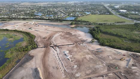 aerial-circling-South-Florida,-land-development,-and-installation-of-infrastructure-for-a-new-neighborhood