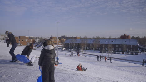 Childs-having-fun-with-sleds-in-an-urban-area-in-slow-motion