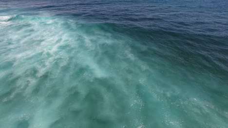 Aerial-seascape-view-of-blue-ocean-waves-representing-freedom-and-tranquility,-background-with-copy-space