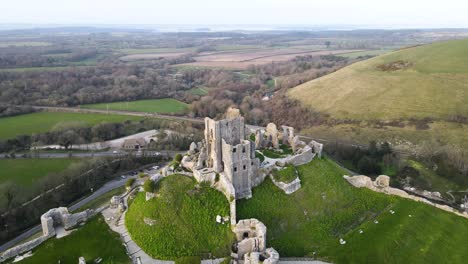 Corfe-Castle-ruins-on-green-hill-at-dusk,-England