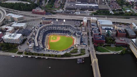Aerial-view-overlooking-the-PNC-Park,-baseball-stadium,-in-the-North-Shore-of-Pittsburgh,-Pennsylvania---tilt,-drone-shot