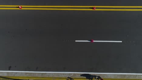 drone-shot-on-the-road-and-cyclists-pedaling-on-their-bicycles