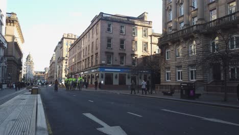 A-group-of-police-officers-and-their-horses-coming-down-a-city-road