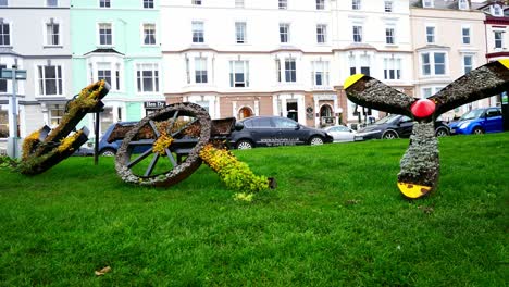 Flowery-anchor-wheel-and-propeller-display-making-word-joy-in-artistic-town-garden-sculpture-dolly-left