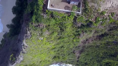 Spectacular-aerial-view-flight-drone-camera-pointing-down-shot-of-edge-rock-cliff-Kelingking-Beach-at-Nusa-Penida-in-Bali-Indonesia-is-like-Jurassic-Park-Cinematic-nature-view-above-by-Philipp-Marnitz